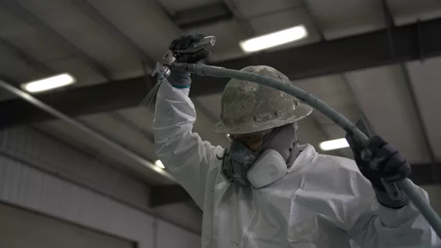 Fireproofing being applied